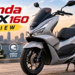 Silver Honda PCX160 premium scooter parked outdoors showing its modern design, LED headlights, and sporty styling for a detailed review article.