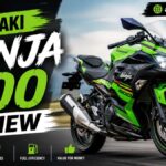 Kawasaki Ninja 500 sportbike parked outdoors, side view showing its trellis frame, dual headlights, and sport fairing