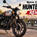 Royal Enfield Hunter 350 motorcycle parked on a city street showcasing its retro-modern design, 349cc engine, alloy wheels, and compact roadster styling.