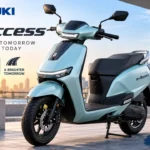 Suzuki e-Access electric scooter parked in an urban environment showcasing its premium design and LED lighting.