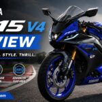 Blue Yamaha R15 V4 sports motorcycle parked on a race track during a detailed review showcasing its sporty design and premium features.