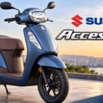 Text: Blue Suzuki Access 125 scooter parked outdoors during golden hour showing modern design and alloy wheels.